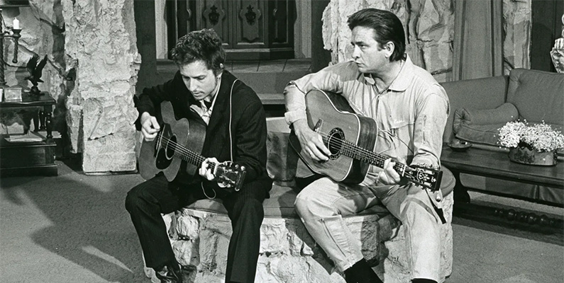 Redan 1962 övervägde Columbia Records möjligheten att avsluta sitt kontrakt med Bob Dylan – detta var innan han hade spelat in sitt andra album, "The Freewheelin' Bob Dylan", som säkrade hans rykte som en levande legend. Ungefär samtidigt blev Dylan och Johnny Cash vänner med varandra. Enligt Hammond var Cashs stöd till Dylan en del av vad som övertygade skivbolaget att hålla fast vid Dylan. Dylans och Cashs vänskap och ömsesidiga stöd fortsatte genom åren; 1969 uppträdde även Dylan i det allra första avsnittet av "The Johnny Cash Show".